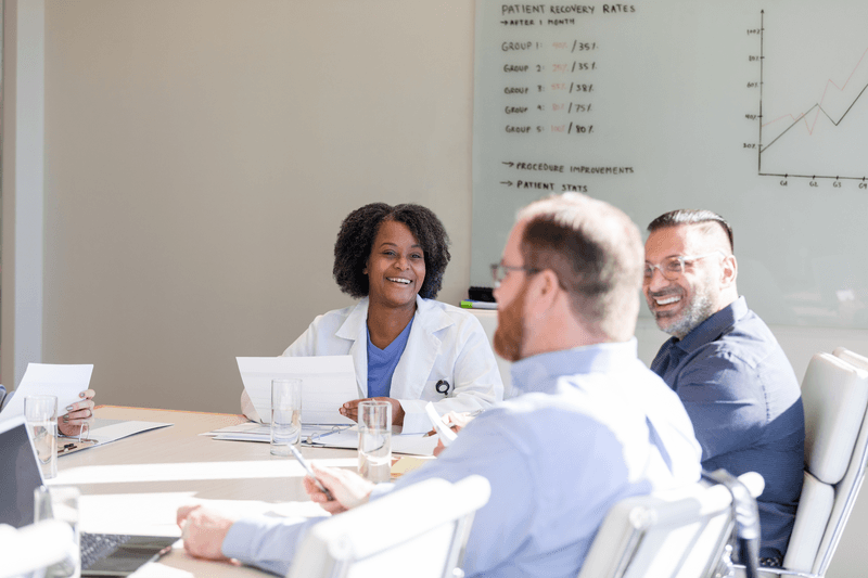 Female surgeon listening to guest speaker - stock photo
The female surgeon smiles and listens to the guest speaker that is addressing the group today.