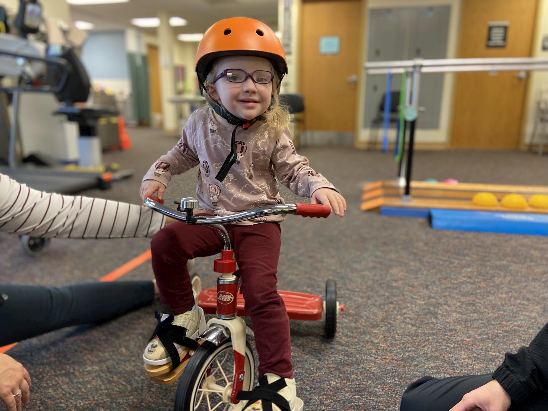 young girl on a tricycle