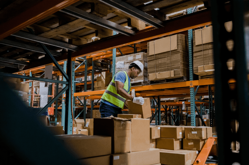 Warehouse employee loading pallet jack - stock photo
The warehouse employee loads the pallet jack up with merchandise he needs to move to another spot.