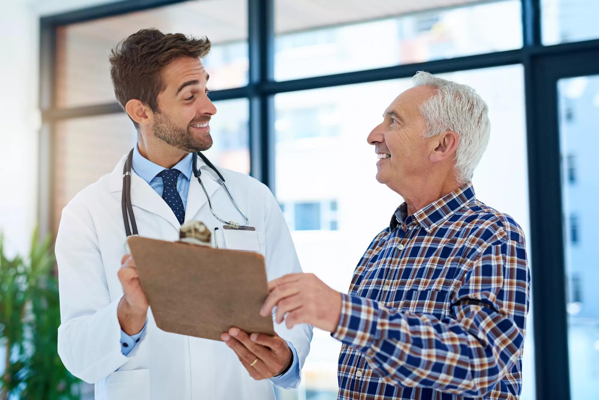 Shot of a cheerful doctor sharing good test results with his mature patient in the hospital